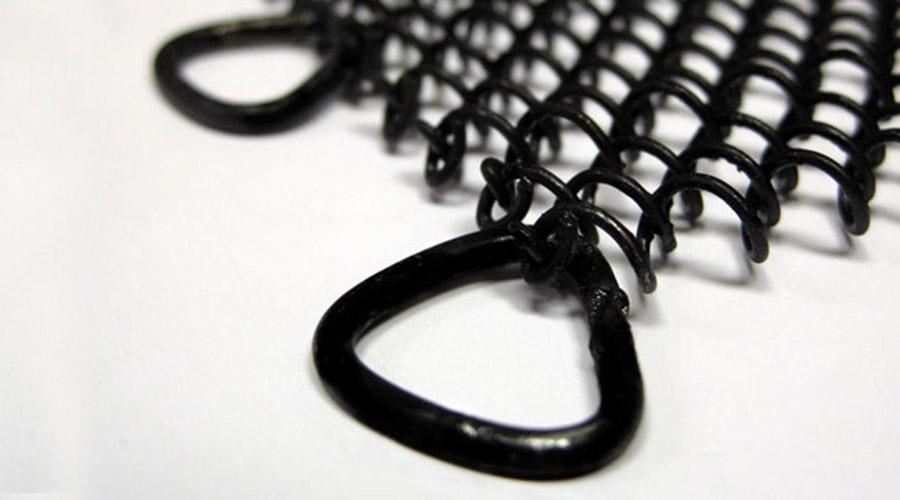 Close-up of ring and black hanging mesh of Condar fireplace screen.